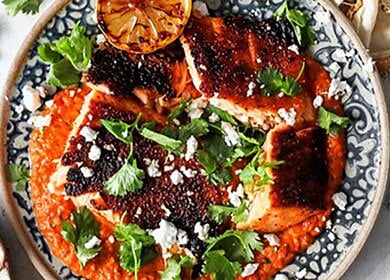 Salmon from Norway over salsa topped with cilantro feta cheese and grilled lemon