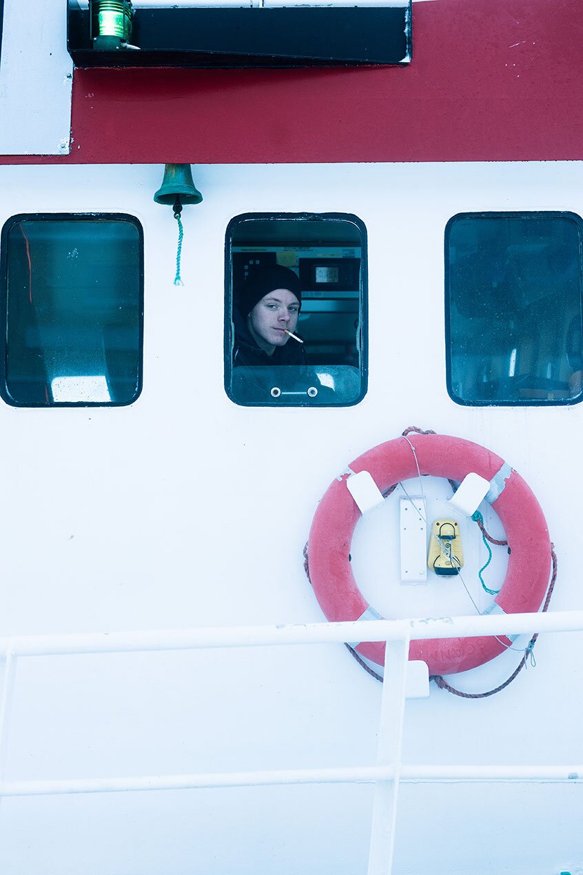 Fisherman in steering house